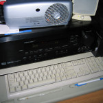On my desk: Projector, audio receiver, keyboard.
